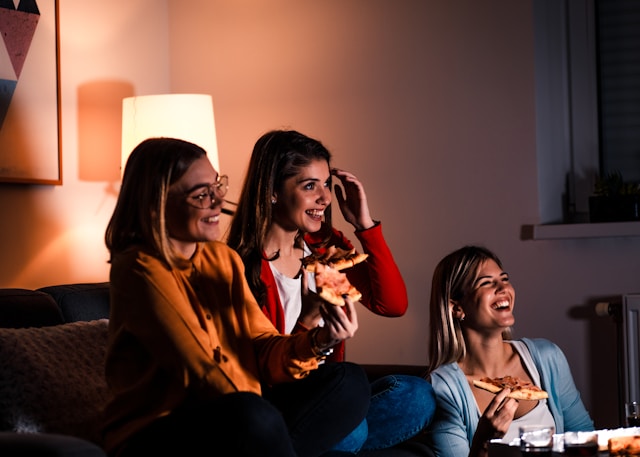 friends laughing while watching tv