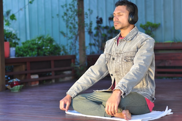 Person meditating with sound waves representing Solfeggio frequencies