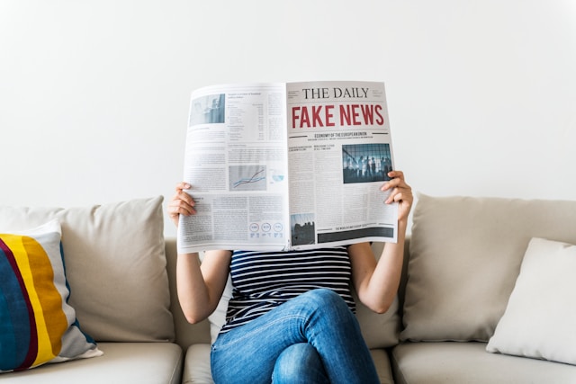 Person reading news and ignoring opposing viewpoints illustrating confirmation bias